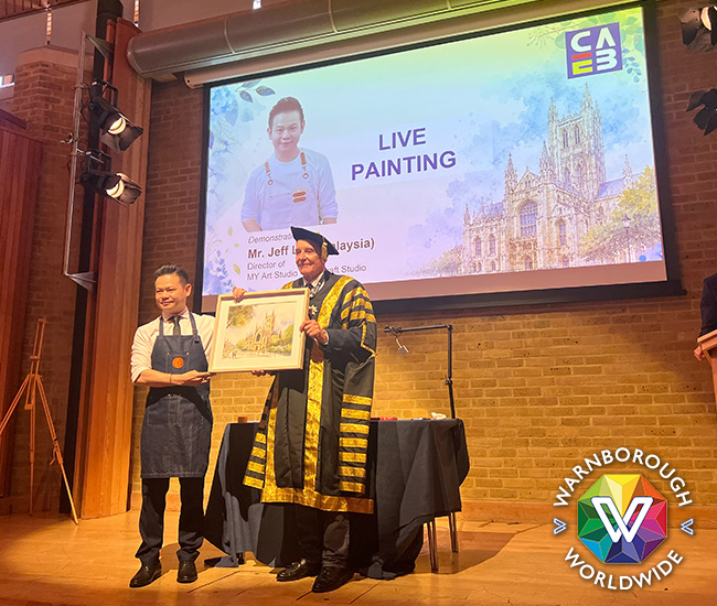 Jeff Lim presents his painting to Dr Brenden Tempest-Mogg